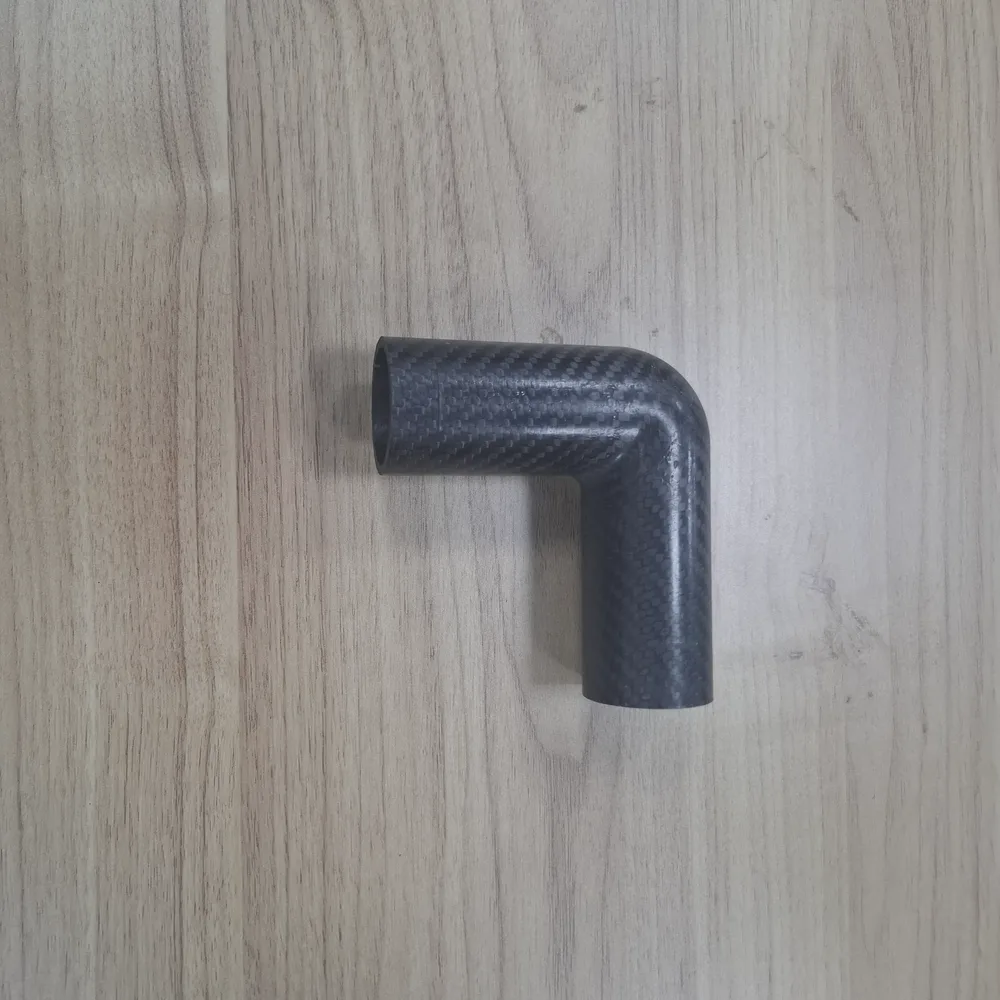 Custom carbon fiber shapes machined from laminate stock Machined carbon fiber tubes and plates prepared as custom shapes