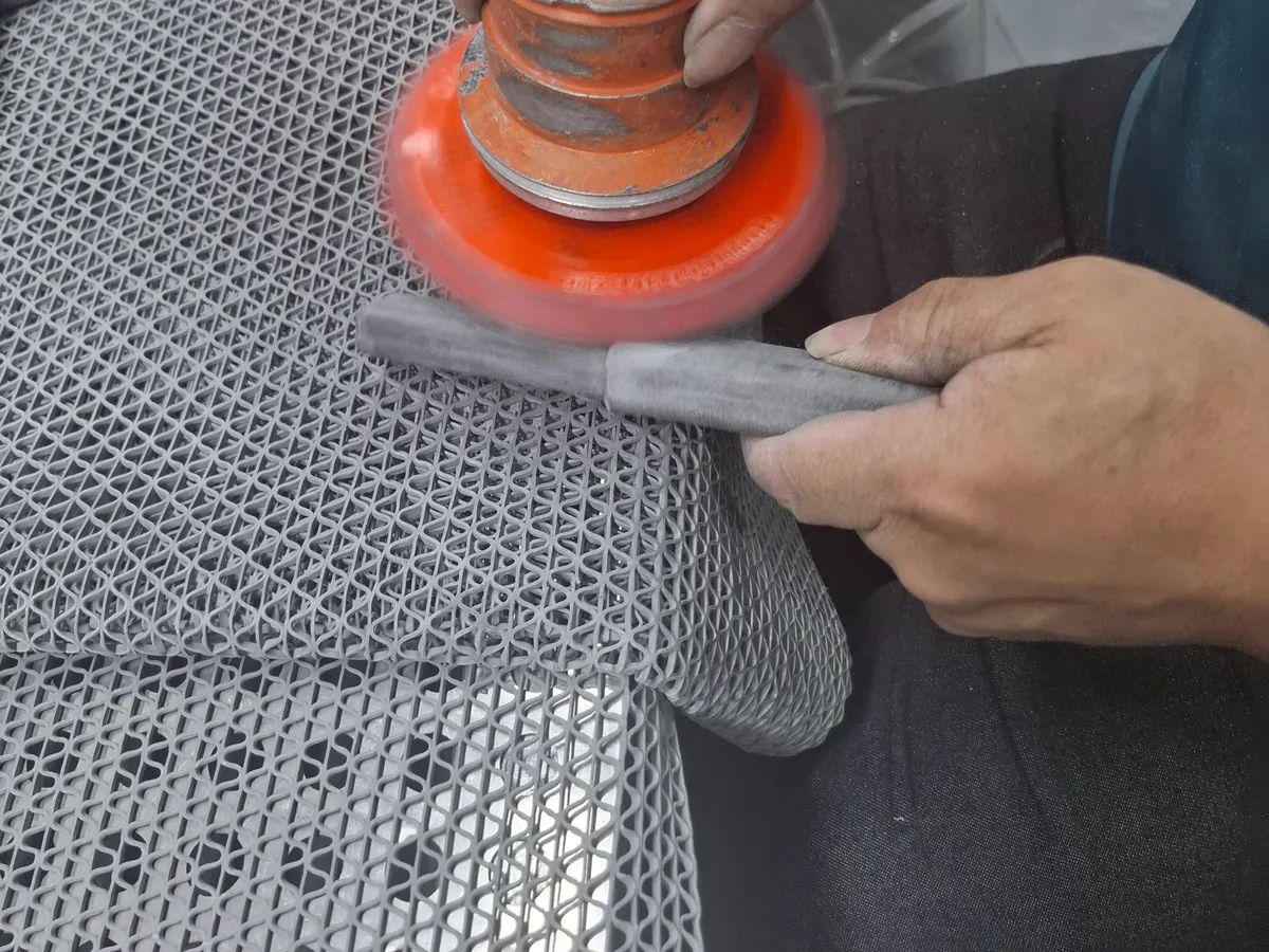 Carbon Fiber Orbital Sanding Orbital sanding a cured carbon fiber tube during surface preparation