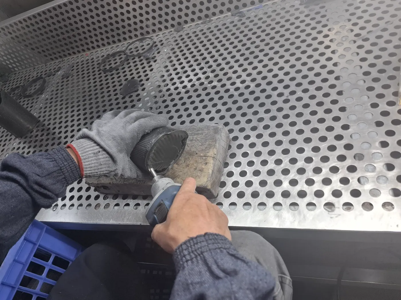 Operator grinding a cured carbon fiber component to final dimension