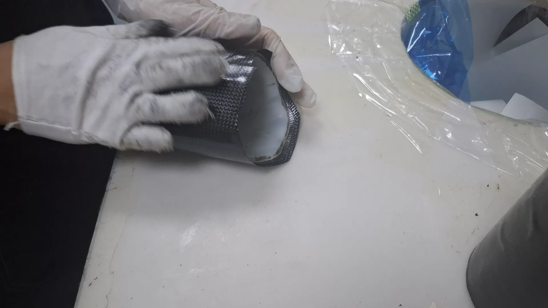 Technician inspecting a carbon fiber prototype tube before assembly
