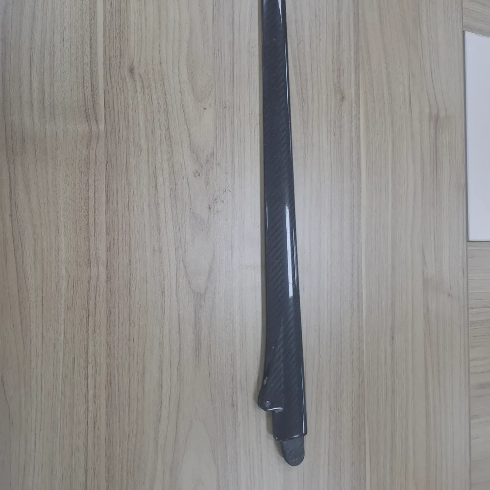 Tapered carbon fiber flat profile with a high-gloss finish Tapered carbon fiber flat profile with a high-gloss finish