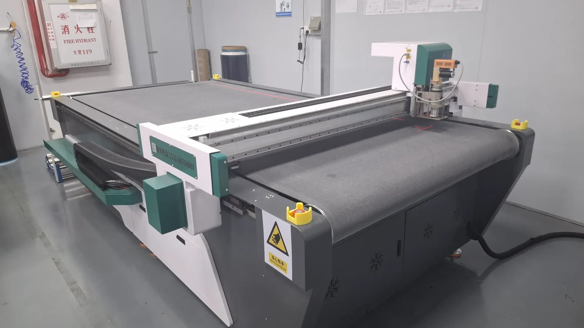 CNC flatbed cutting machine preparing carbon fiber prepreg plies