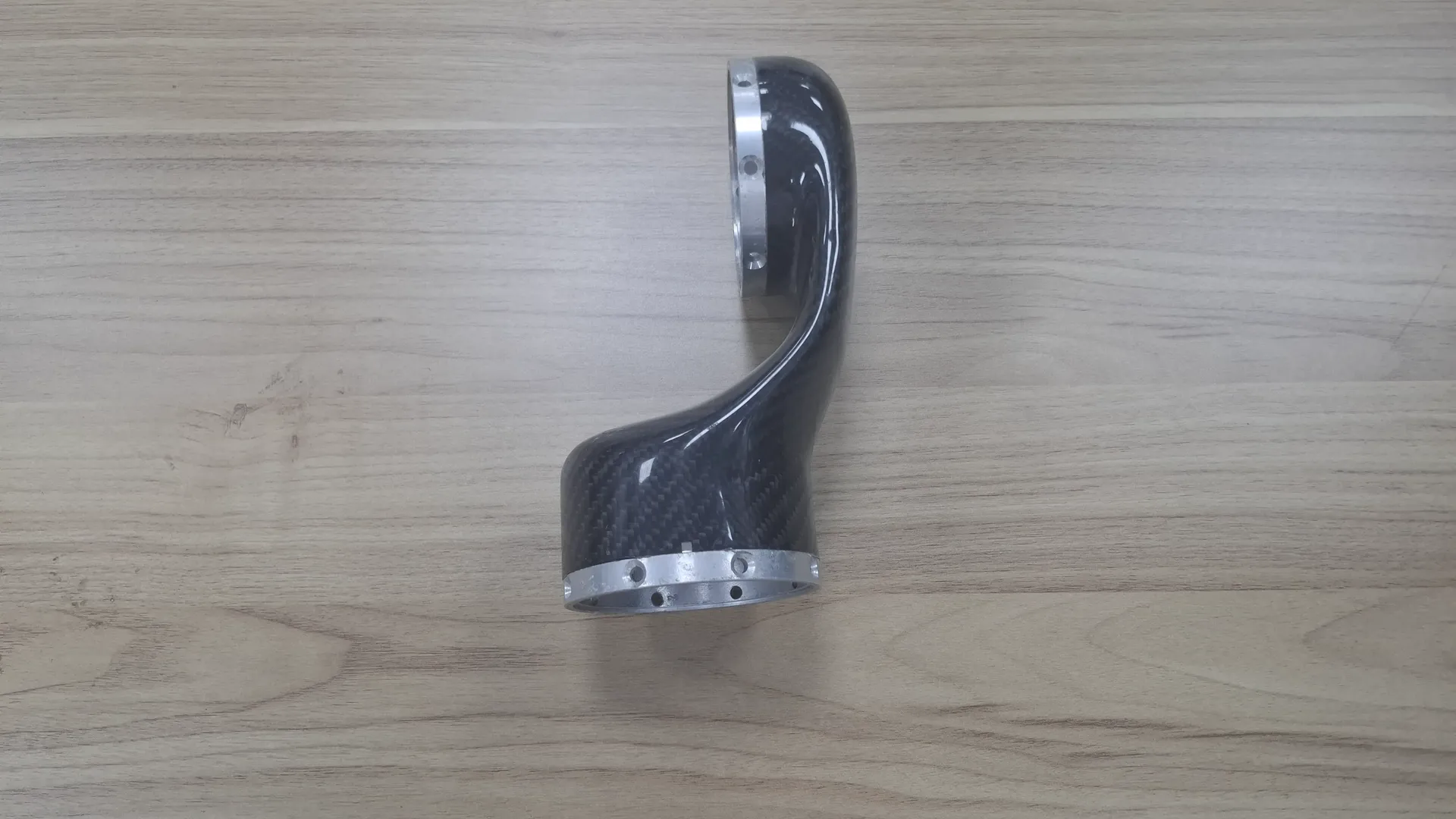 Custom moulded carbon fiber duct with bonded aluminium mounting flanges